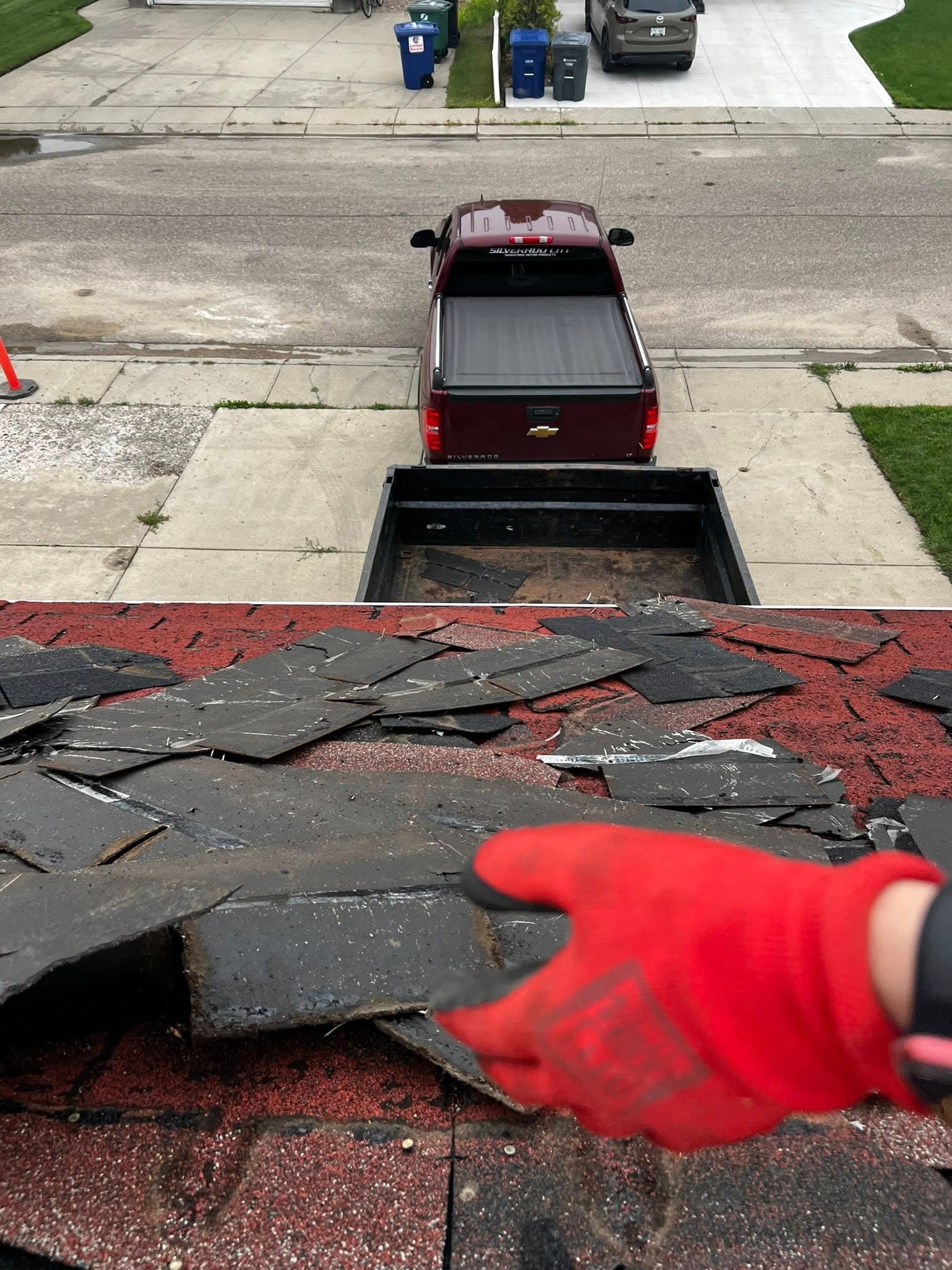 WLG Homes crew removing old shingles during a roof replacement in Saskatoon
